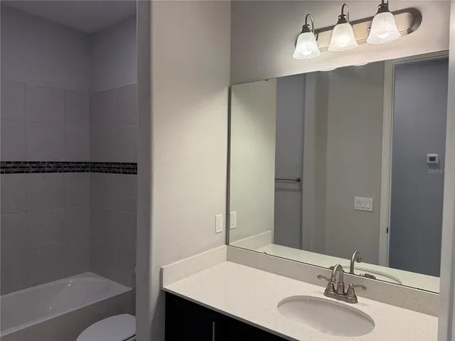 a small space with a window and a fan