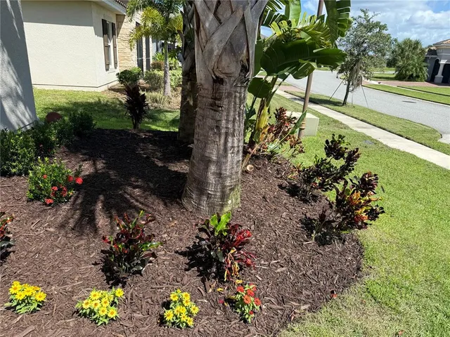 an aerial view of a house with a yard and lake view