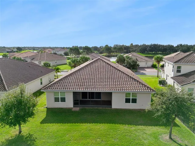 aerial view of a house next to a yard