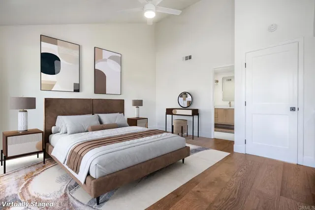 a bedroom with a bed and closet with mirror