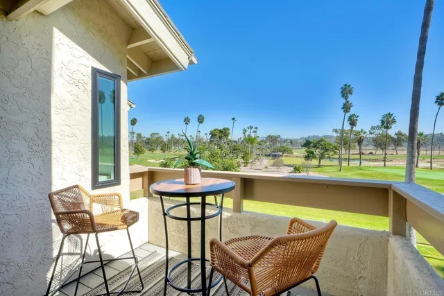 a view of a chairs and table in patio with a lake view