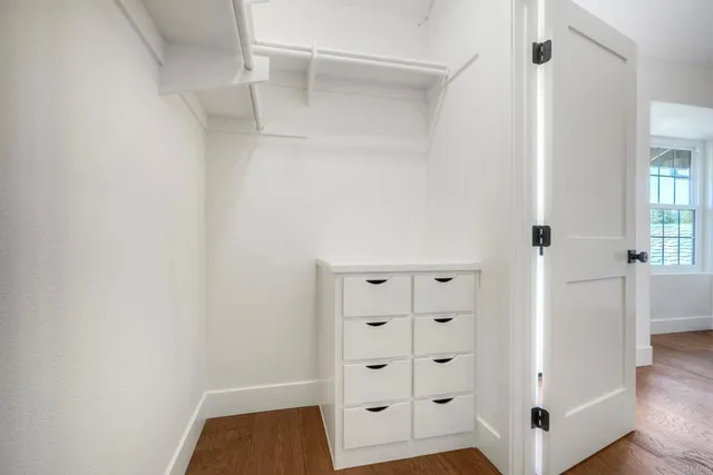 a view of walk in closet with white walls