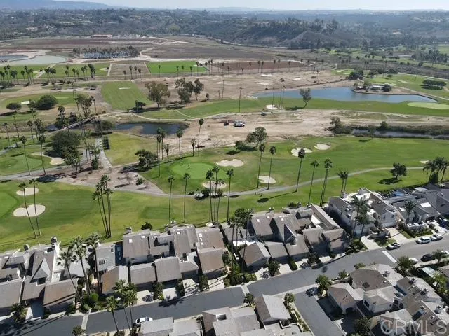 an aerial view of residential houses with outdoor space and lake view