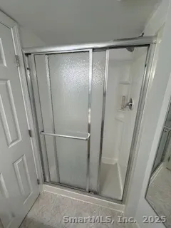 a bathroom with a glass shower door