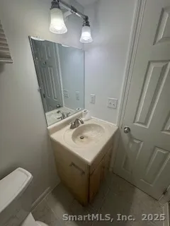 a bathroom with a sink toilet and vanity
