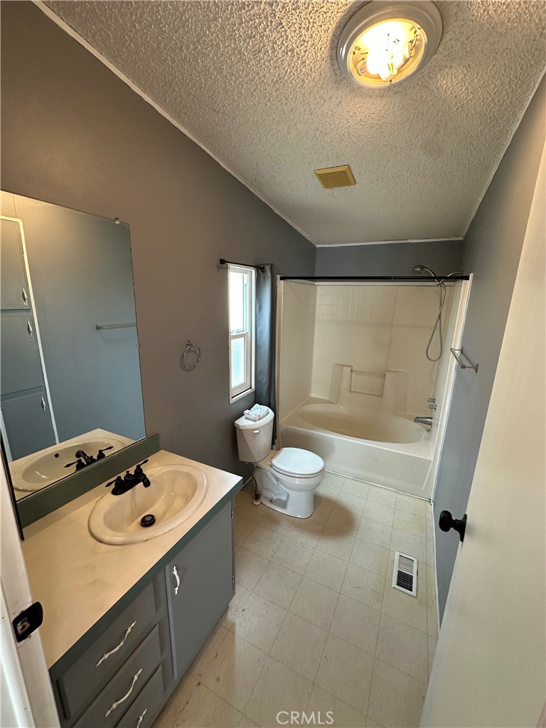 3825 Crestmore Road, Unit 414 Riverside, CA 92509 - Photo 13 of 31 a bathroom with a sink a toilet a mirror and shower