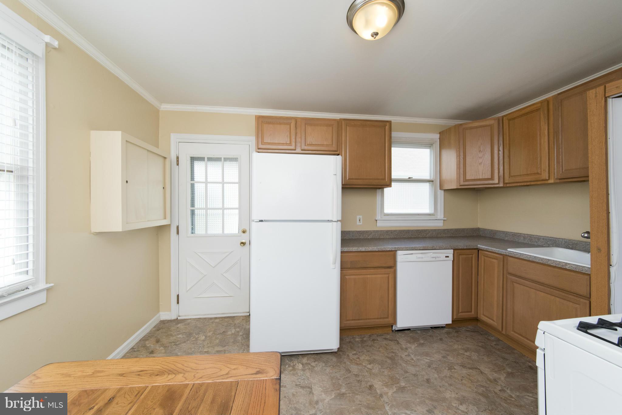 3117 Cornwall Road Baltimore, MD 21222 - Photo 11 of 30 a kitchen with a refrigerator and a sink
