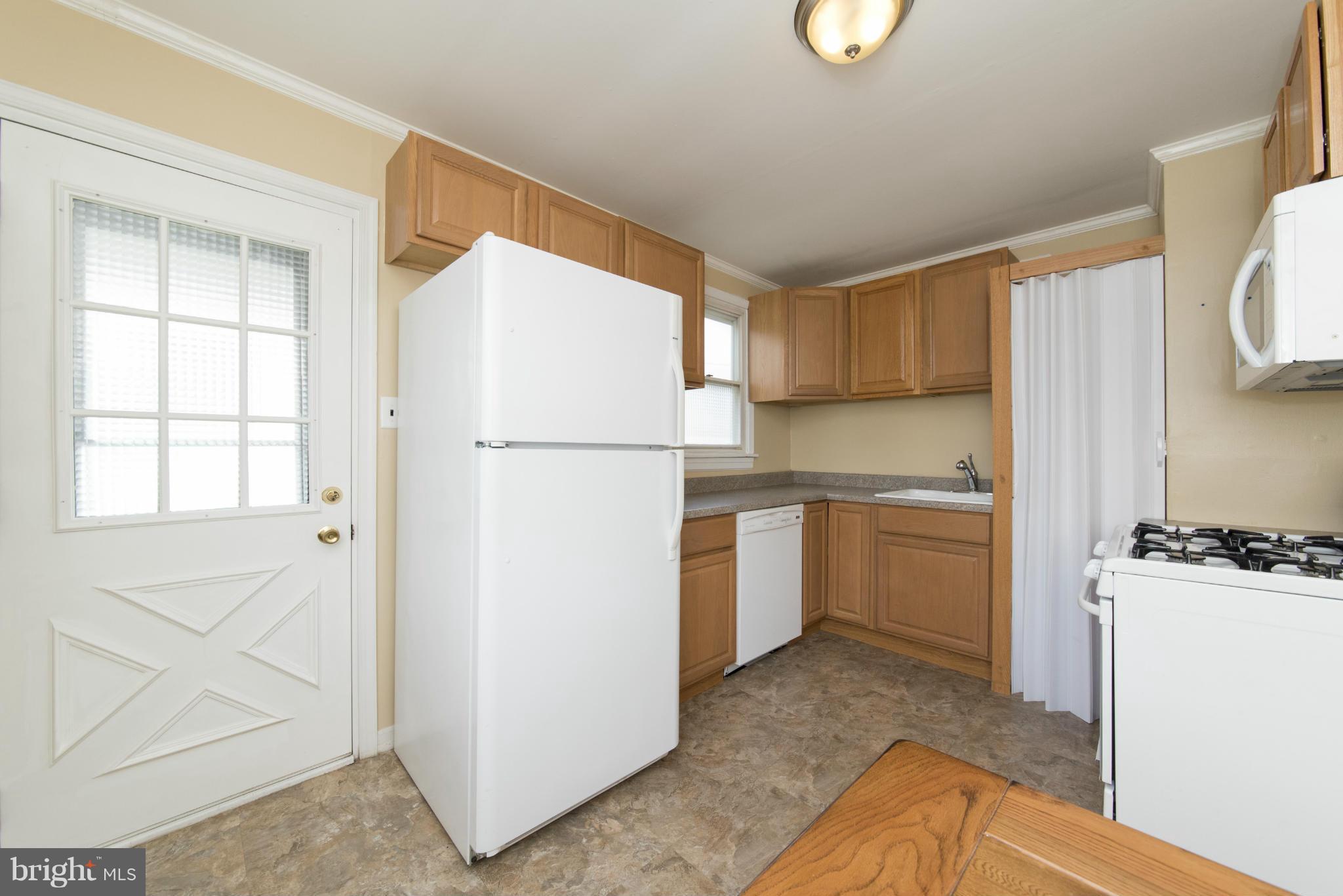 3117 Cornwall Road Baltimore, MD 21222 - Photo 12 of 30 a kitchen with a refrigerator sink stove and cabinets