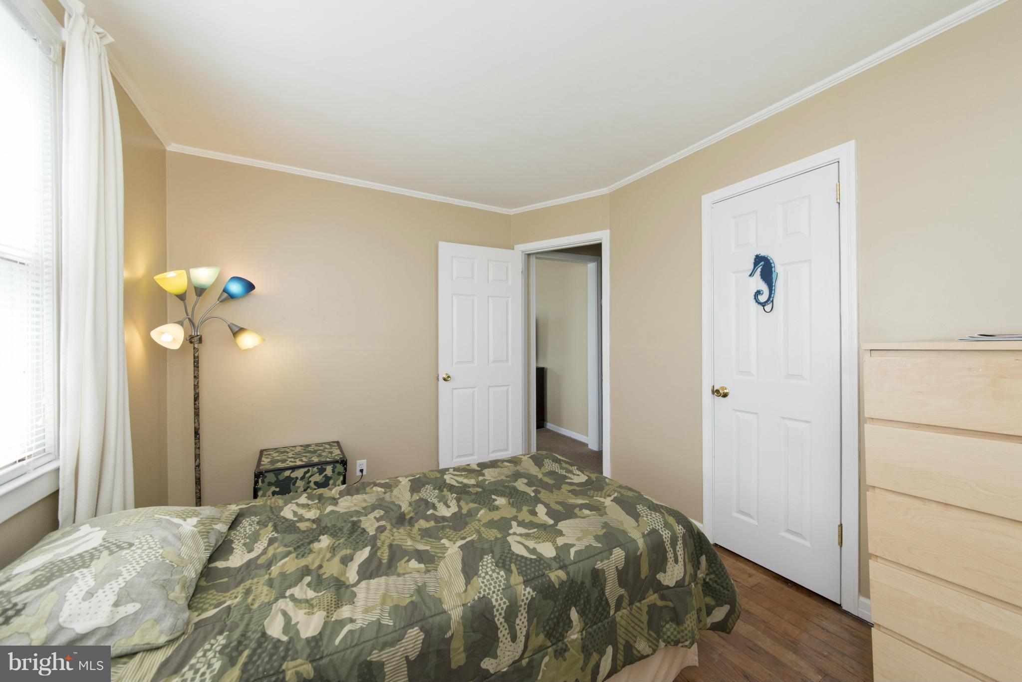 3117 Cornwall Road Baltimore, MD 21222 - Photo 14 of 30 a bedroom with a bed and a chandelier