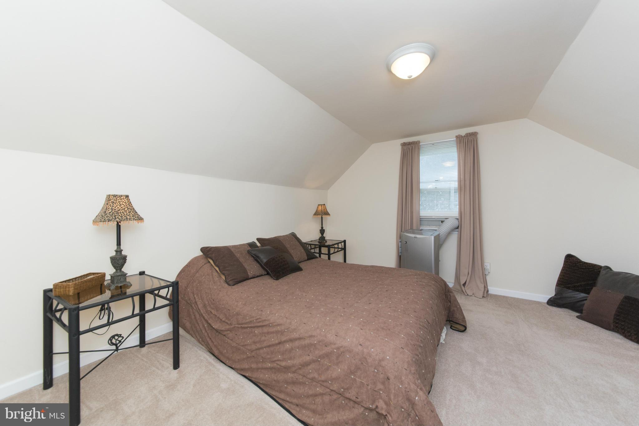 3117 Cornwall Road Baltimore, MD 21222 - Photo 21 of 30 a bedroom with a bed and a night stand