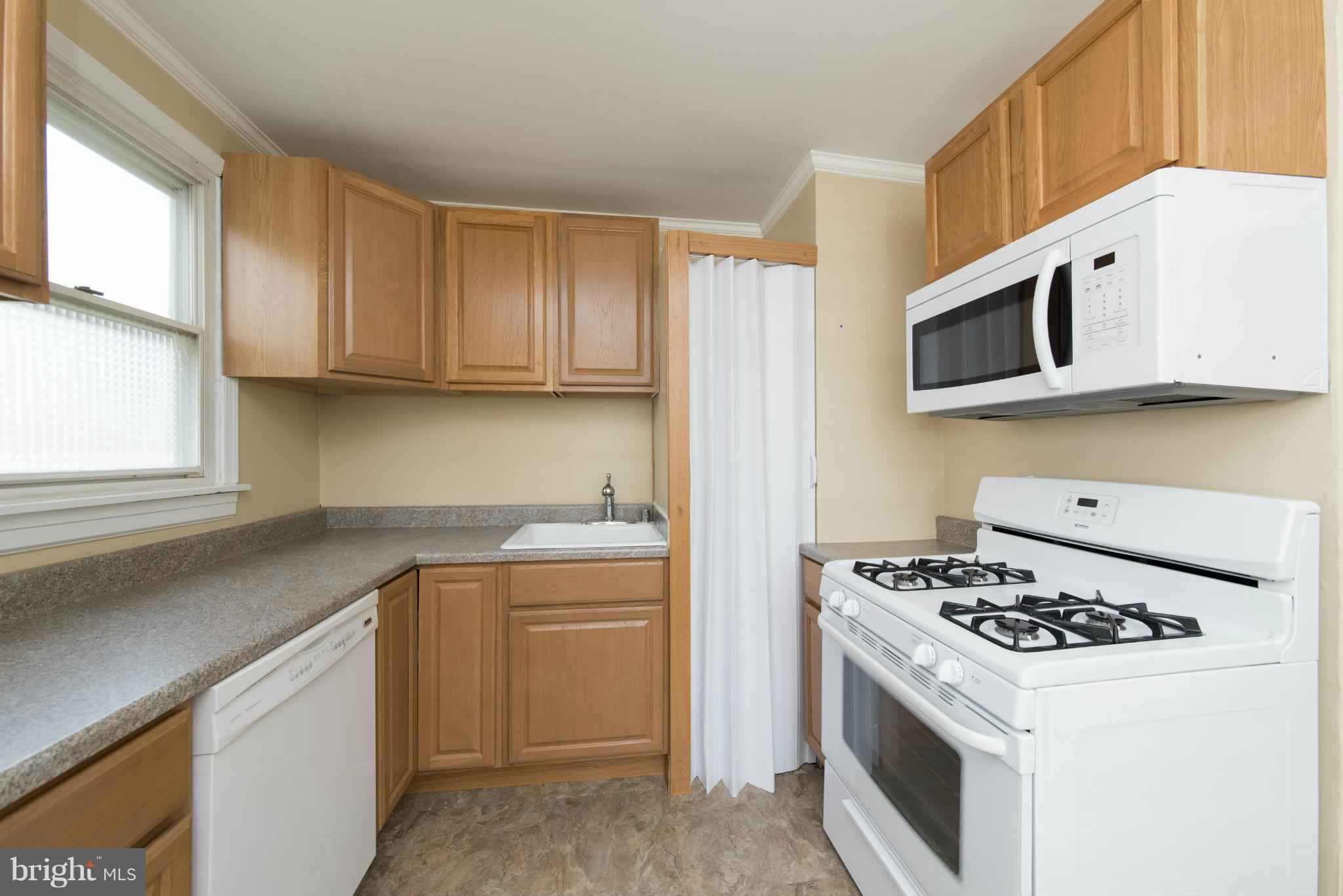 3117 Cornwall Road Baltimore, MD 21222 - Photo 9 of 30 a kitchen with stainless steel appliances a stove a sink and a microwave