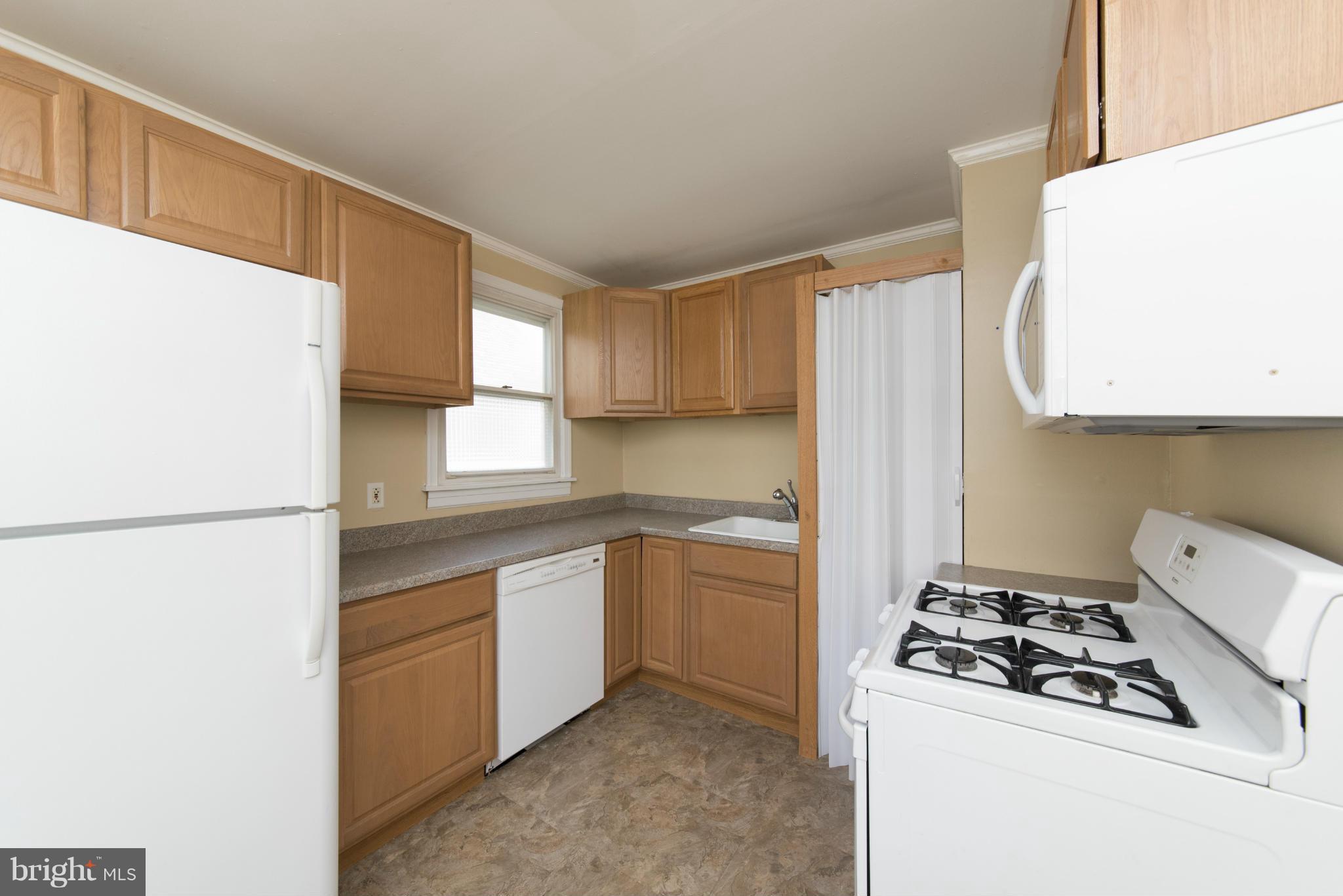 3117 Cornwall Road Baltimore, MD 21222 - Photo 10 of 30 a kitchen with sink a refrigerator and a stove