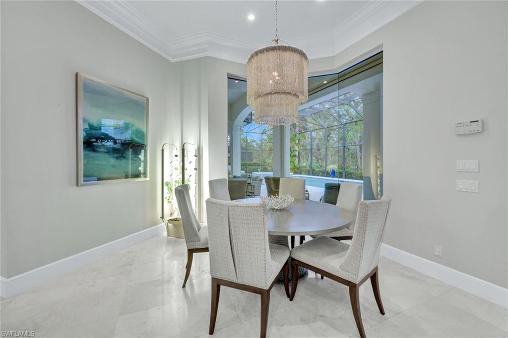 253 Cheshire Way Naples, FL 34110 - Photo 19 of 50 Dining space with a chandelier, ornamental molding, and a sunroom