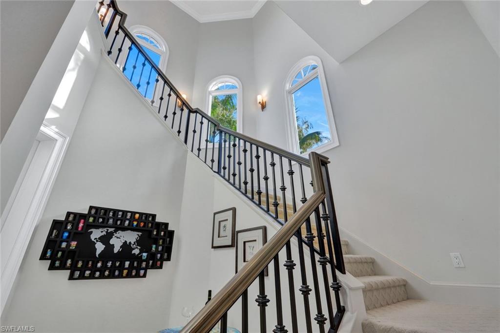 253 Cheshire Way Naples, FL 34110 - Photo 21 of 50 Staircase featuring a towering ceiling
