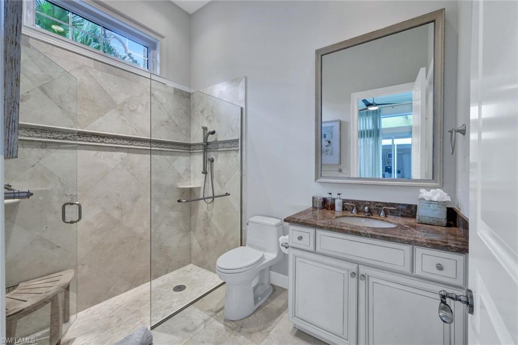 253 Cheshire Way Naples, FL 34110 - Photo 28 of 50 Full bath with a stall shower and vanity
