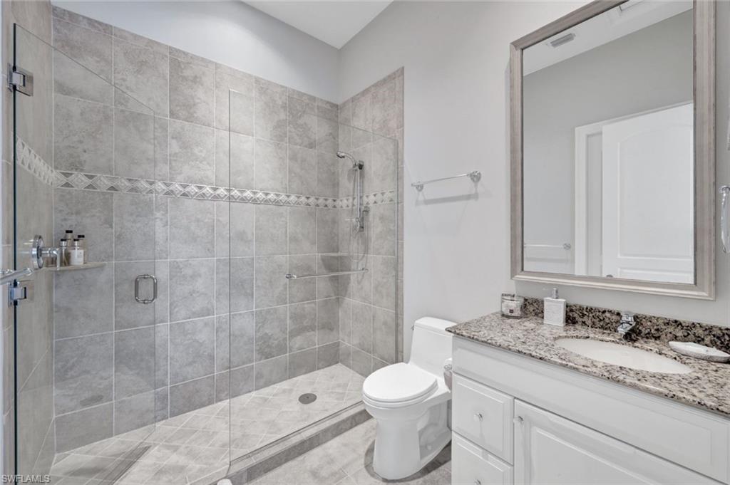253 Cheshire Way Naples, FL 34110 - Photo 35 of 50 Bathroom featuring vanity and a stall shower