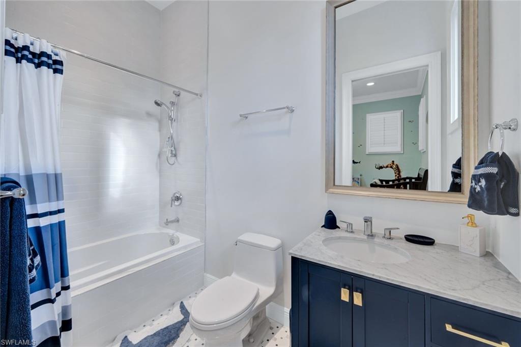 253 Cheshire Way Naples, FL 34110 - Photo 37 of 50 Bathroom with shower / bath combination with curtain and vanity