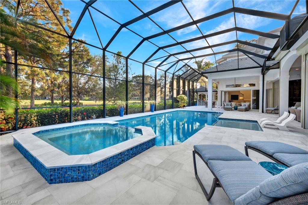 253 Cheshire Way Naples, FL 34110 - Photo 46 of 50 View of pool with a patio area, a sunroom, a pool with connected hot tub, an outdoor hangout area, and glass enclosure
