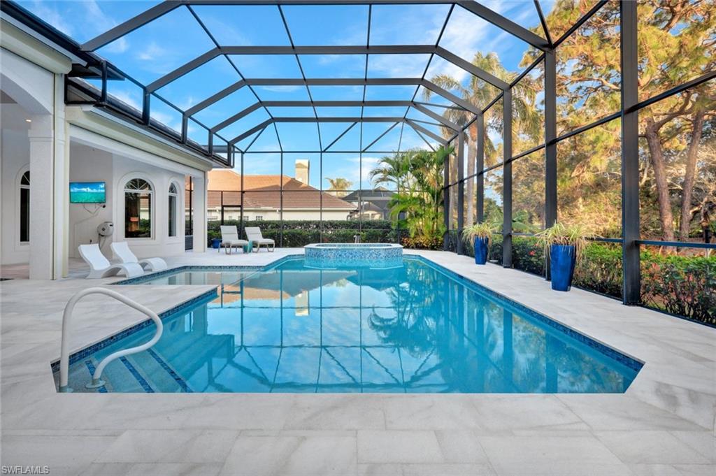 253 Cheshire Way Naples, FL 34110 - Photo 49 of 50 View of swimming pool with a sunroom, a patio, a pool with connected hot tub, and a lanai