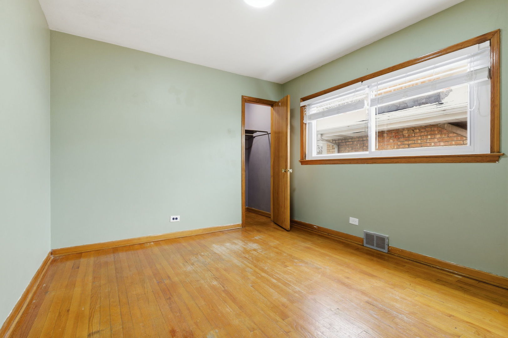 7023 29th Place Berwyn, IL 60402 - Photo 12 of 36 a view of an empty room with wooden floor and a window