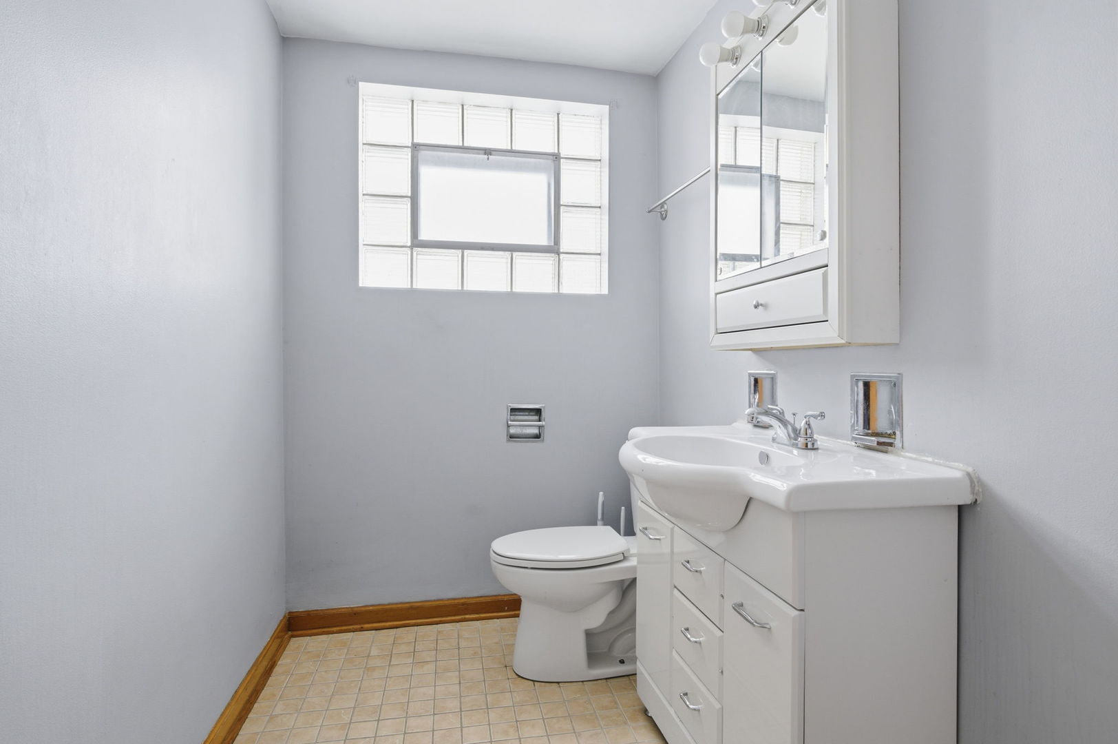 7023 29th Place Berwyn, IL 60402 - Photo 16 of 36 a bathroom with a sink a toilet and a window