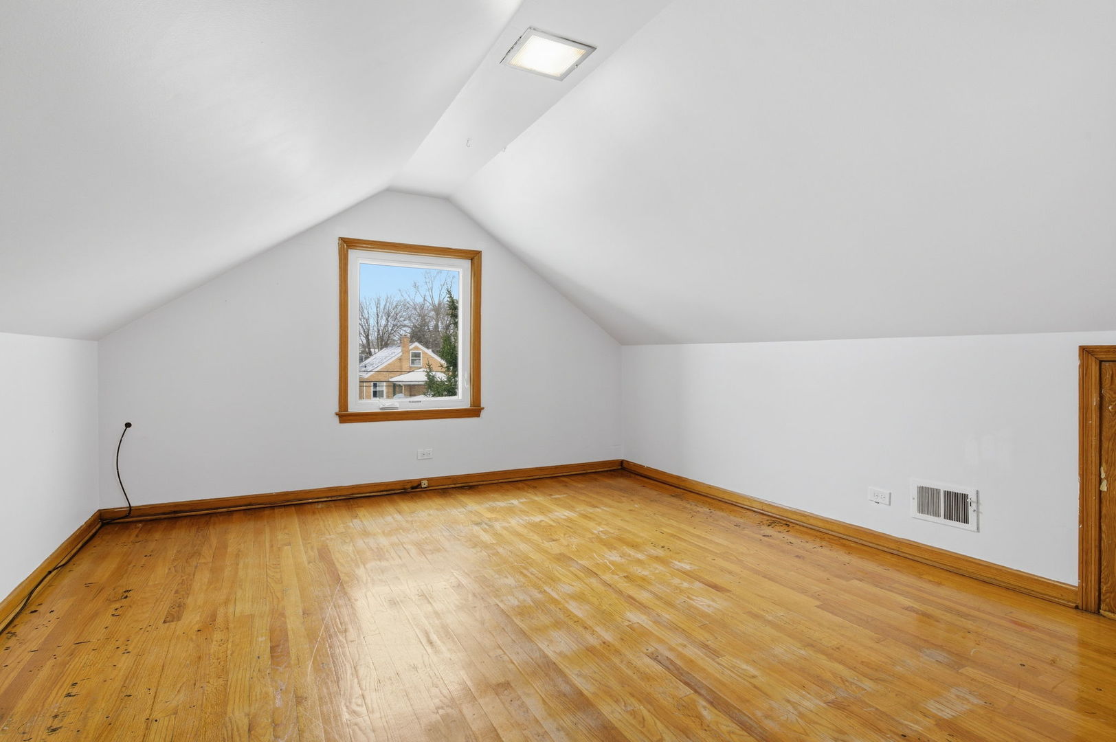 7023 29th Place Berwyn, IL 60402 - Photo 17 of 36 a view of a room with wooden floor and window