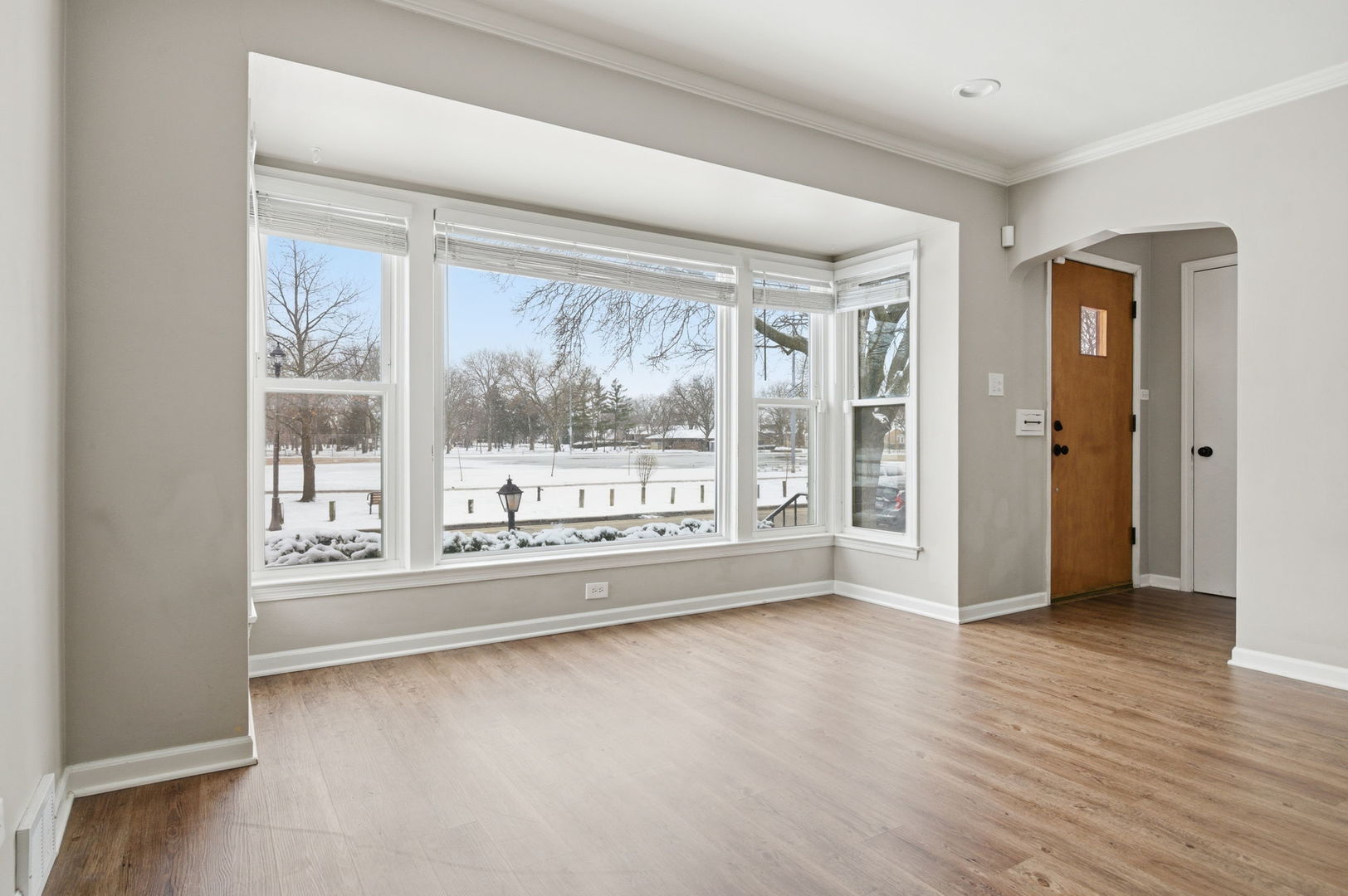 7023 29th Place Berwyn, IL 60402 - Photo 3 of 36 a view of an empty room with wooden floor and a window