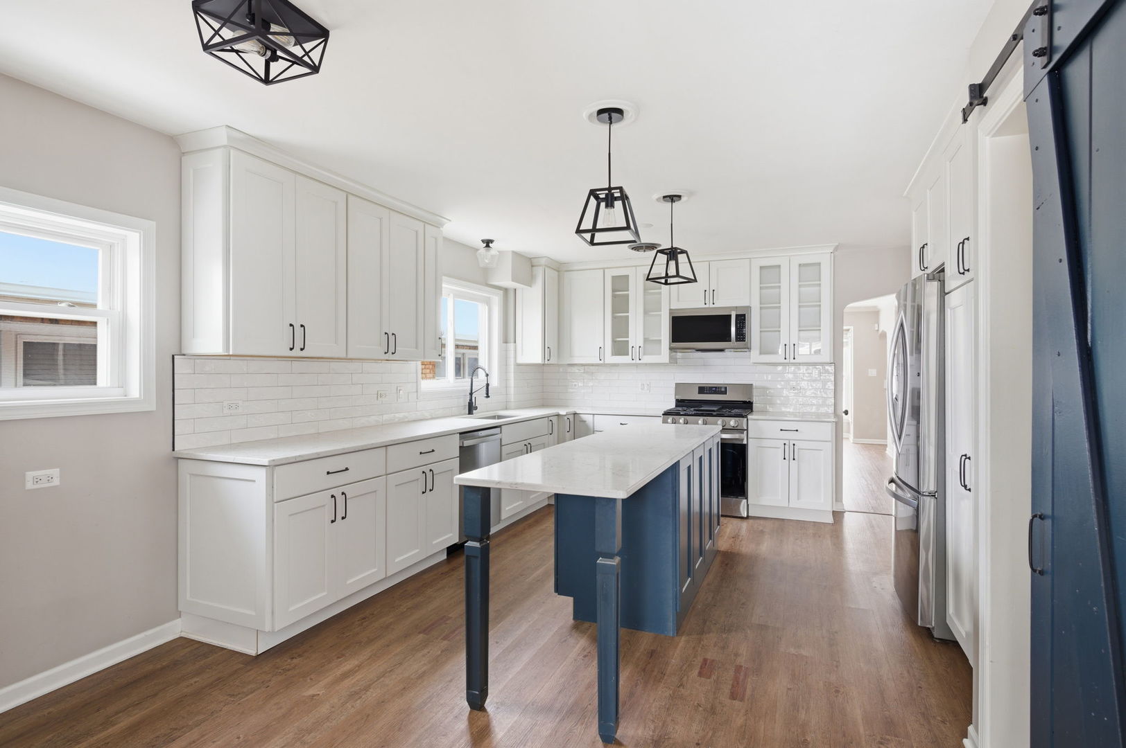 7023 29th Place Berwyn, IL 60402 - Photo 10 of 36 a kitchen with stainless steel appliances granite countertop a refrigerator a stove a sink dishwasher a oven with white cabinets and wooden floor