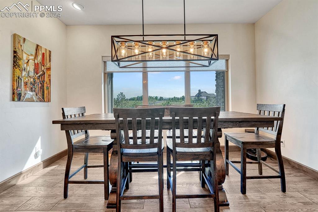 19210 Royal Troon Drive Monument, CO 80132 - Photo 17 of 50 a dining room with a wooden table and chairs