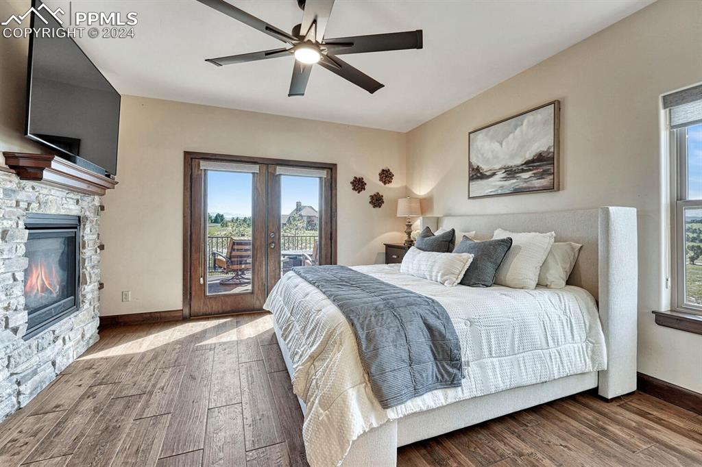 19210 Royal Troon Drive Monument, CO 80132 - Photo 22 of 50 a spacious bedroom with a bed and a flat screen tv