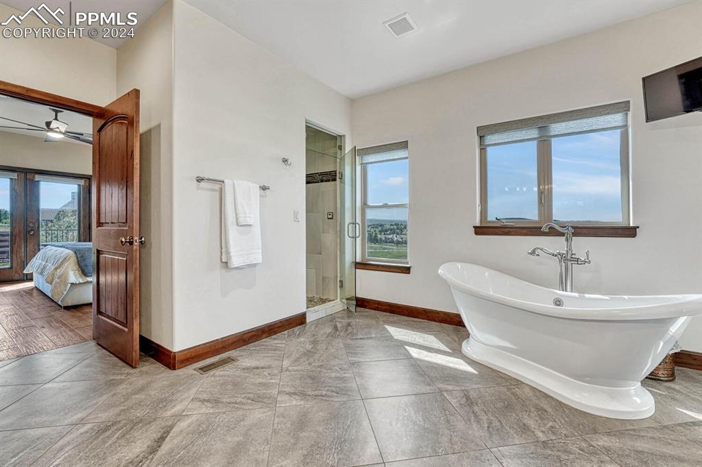 19210 Royal Troon Drive Monument, CO 80132 - Photo 25 of 50 a spacious bathroom with a tub and shower