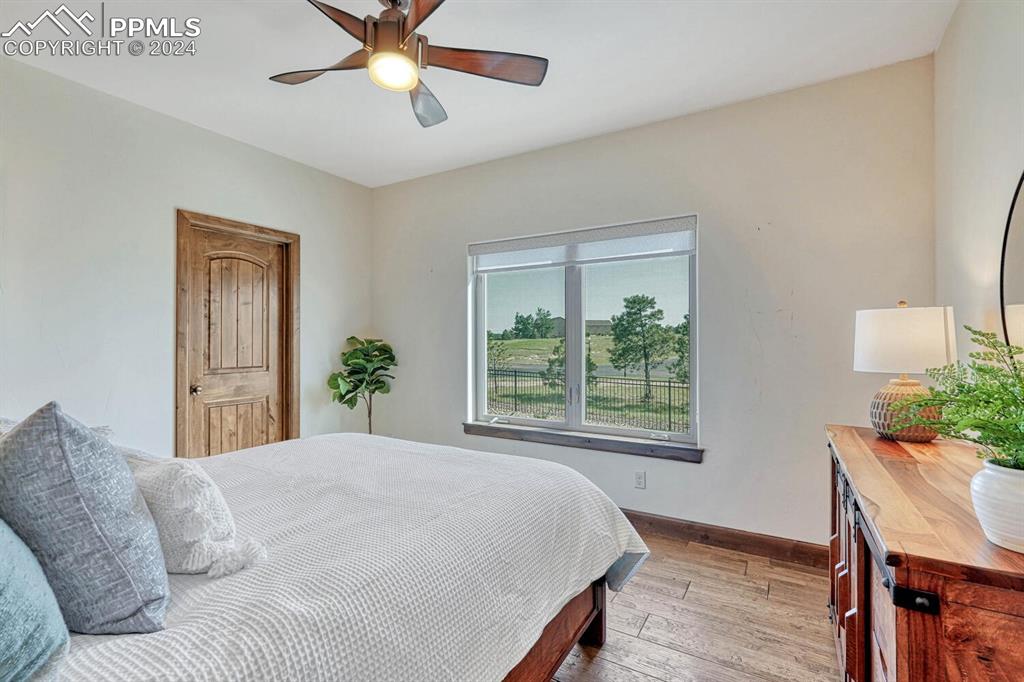 19210 Royal Troon Drive Monument, CO 80132 - Photo 30 of 50 a bedroom with a large bed and a window