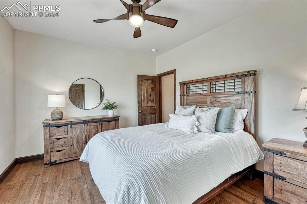 19210 Royal Troon Drive Monument, CO 80132 - Photo 31 of 50 a bedroom with a bed a mirror and on dresser