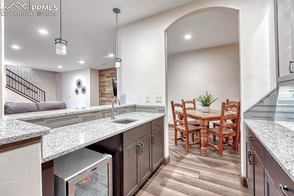 19210 Royal Troon Drive Monument, CO 80132 - Photo 34 of 50 a kitchen with granite countertop kitchen island stainless steel appliances a sink stove and cabinets
