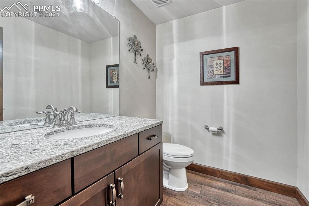 19210 Royal Troon Drive Monument, CO 80132 - Photo 40 of 50 a bathroom with a granite countertop sink toilet and a mirror