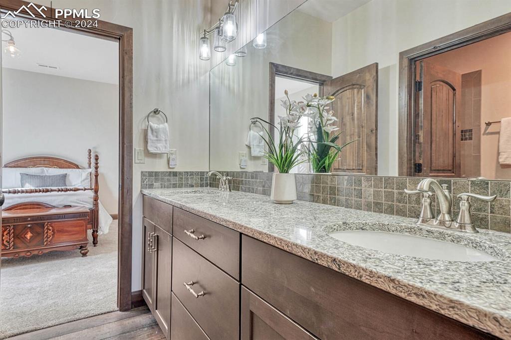 19210 Royal Troon Drive Monument, CO 80132 - Photo 42 of 50 a bathroom with a granite countertop sink and a mirror