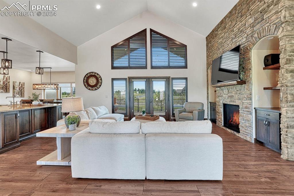 19210 Royal Troon Drive Monument, CO 80132 - Photo 5 of 50 a living room with furniture a fireplace and a clock