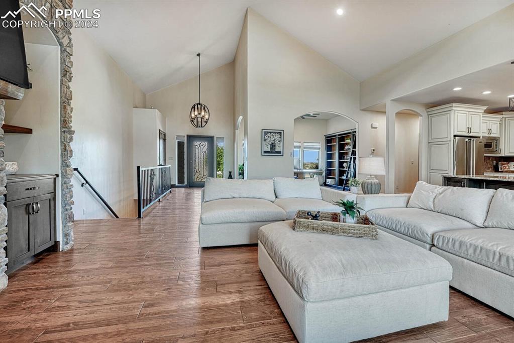 19210 Royal Troon Drive Monument, CO 80132 - Photo 8 of 50 a living room with furniture and a chandelier