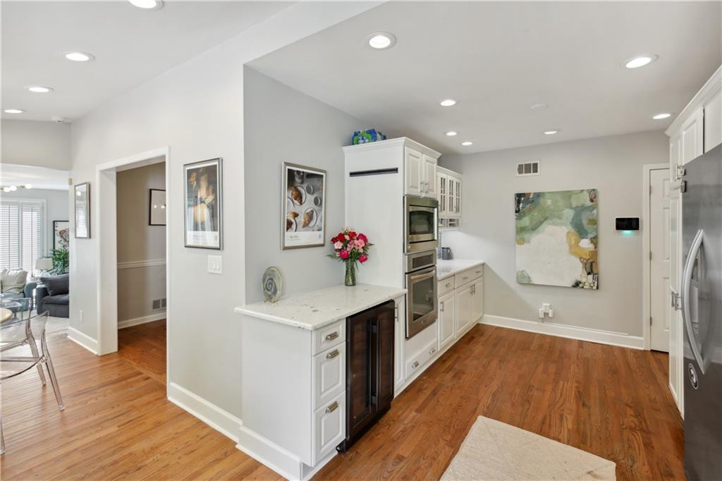 1403 Moores Mill Road Northwest Atlanta, GA 30327 - Photo 11 of 30 a kitchen with stainless steel appliances a stove top oven a refrigerator and cabinets