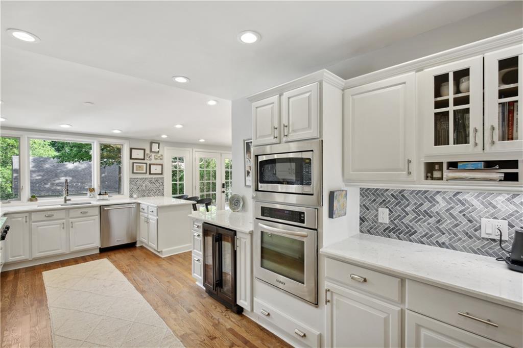 1403 Moores Mill Road Northwest Atlanta, GA 30327 - Photo 12 of 30 a kitchen with granite countertop a sink and stainless steel appliances