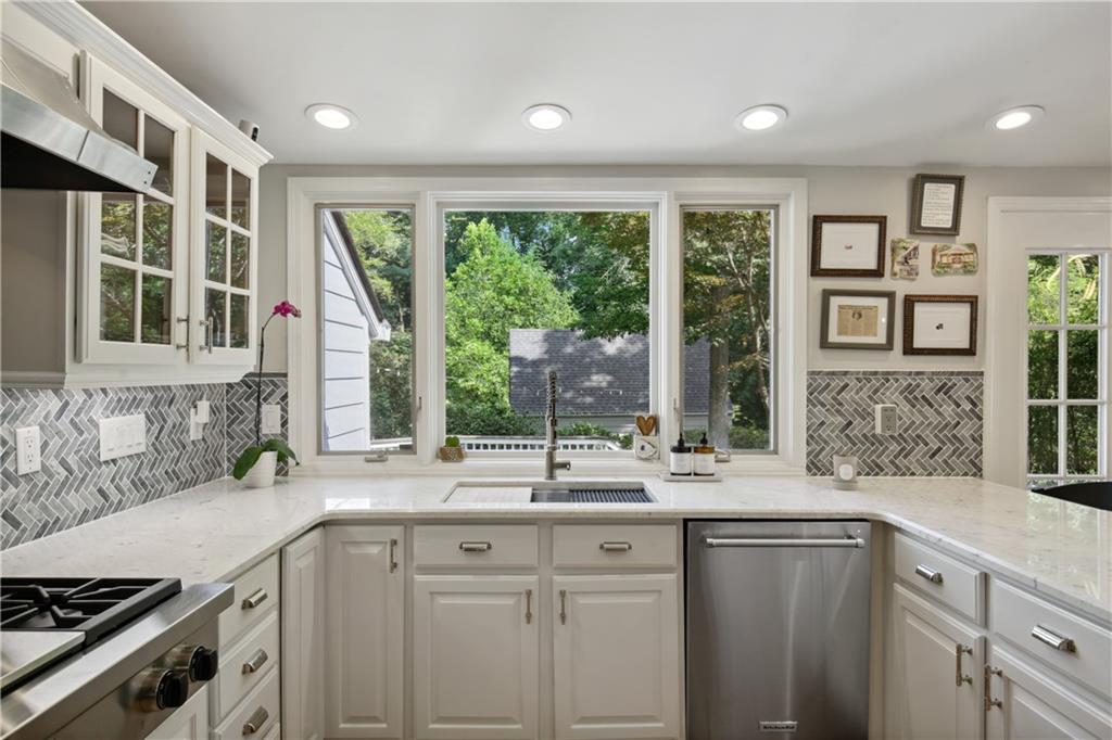 1403 Moores Mill Road Northwest Atlanta, GA 30327 - Photo 13 of 30 a kitchen with granite countertop a sink and a window