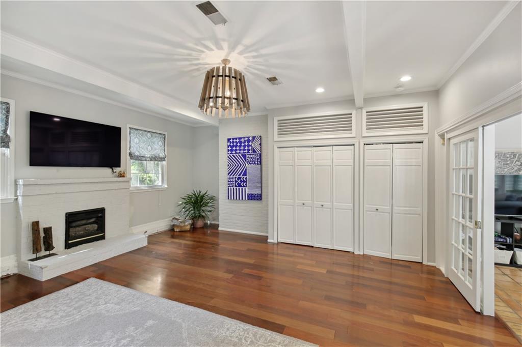1403 Moores Mill Road Northwest Atlanta, GA 30327 - Photo 17 of 30 a living room with fireplace furniture and a flat screen tv