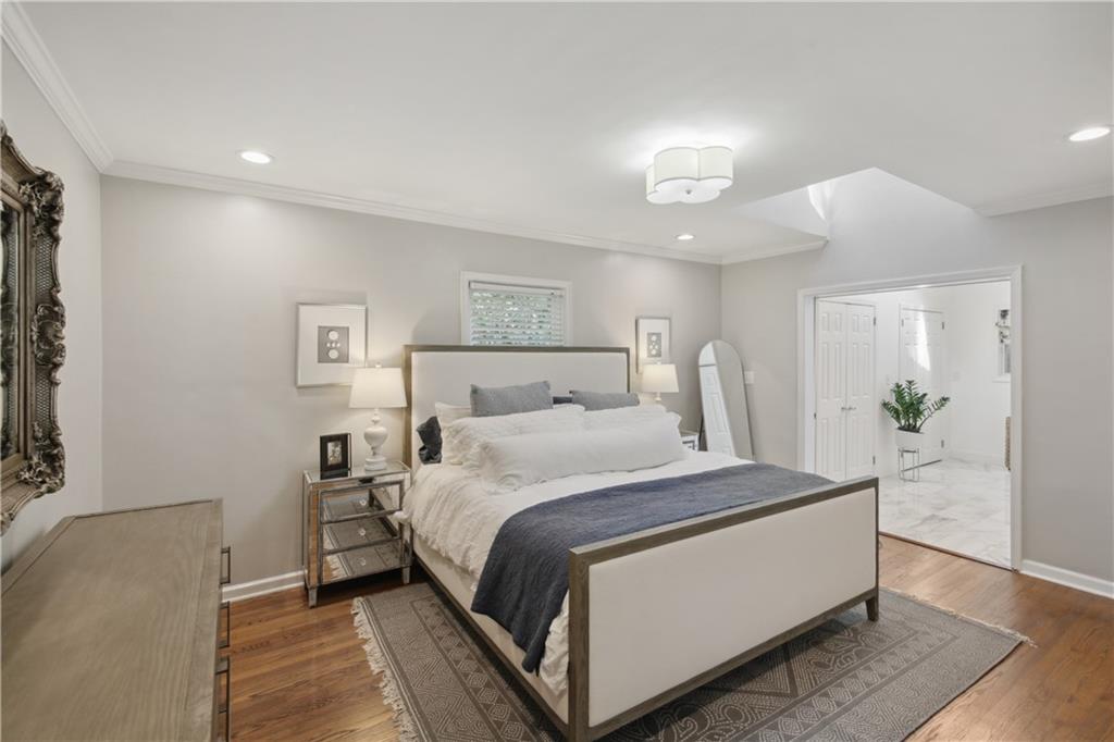 1403 Moores Mill Road Northwest Atlanta, GA 30327 - Photo 19 of 30 a bedroom with a bed and a potted plant