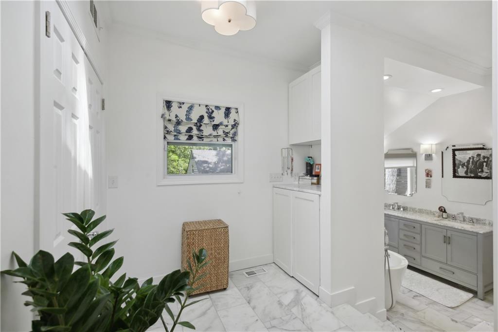 1403 Moores Mill Road Northwest Atlanta, GA 30327 - Photo 20 of 30 a view of a hallway with entryway and chandelier