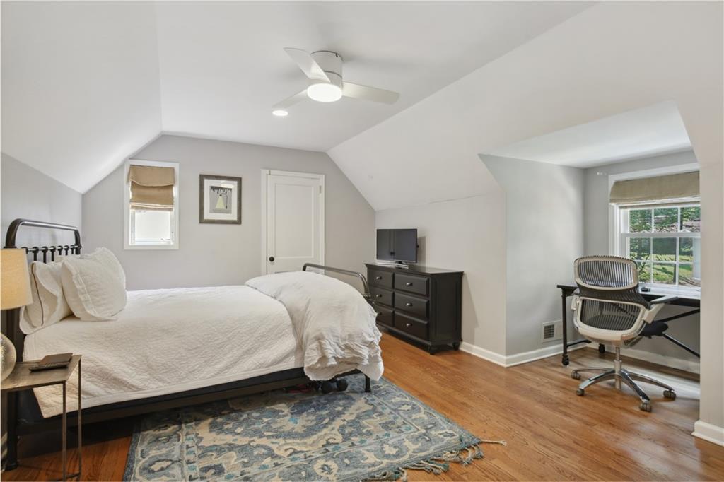 1403 Moores Mill Road Northwest Atlanta, GA 30327 - Photo 27 of 30 a bedroom with a bed a chair and potted plant on the dresser