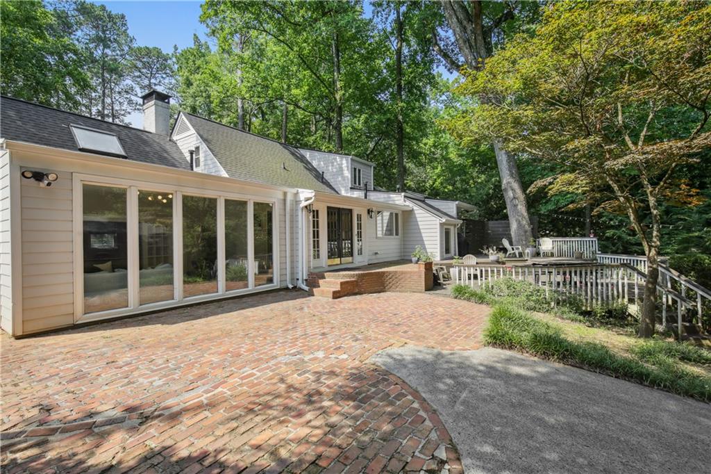 1403 Moores Mill Road Northwest Atlanta, GA 30327 - Photo 28 of 30 a front view of a house with a garden