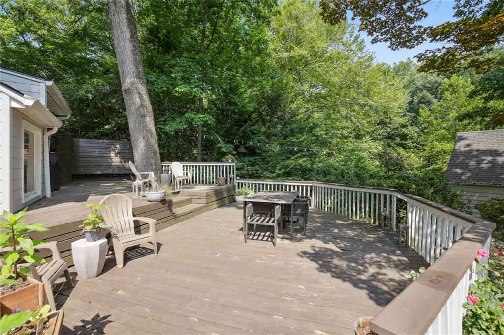 1403 Moores Mill Road Northwest Atlanta, GA 30327 - Photo 30 of 30 a view of a patio with a table and chairs