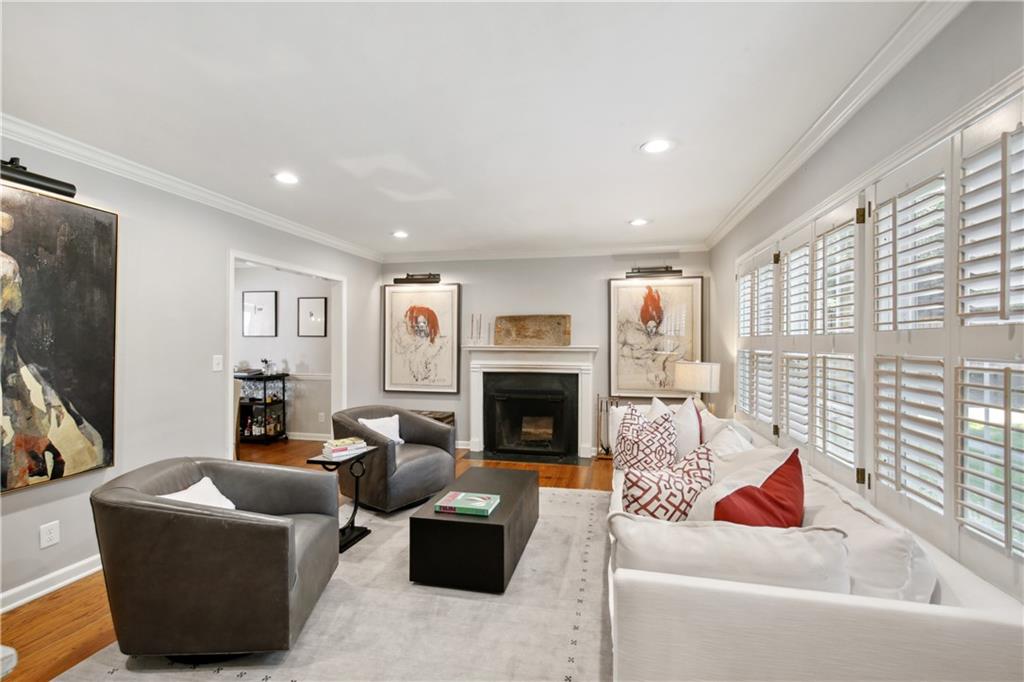 1403 Moores Mill Road Northwest Atlanta, GA 30327 - Photo 6 of 30 a living room with furniture a fireplace and a flat screen tv
