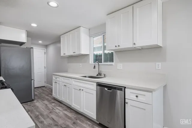 a kitchen with stainless steel appliances granite countertop a sink and a stove