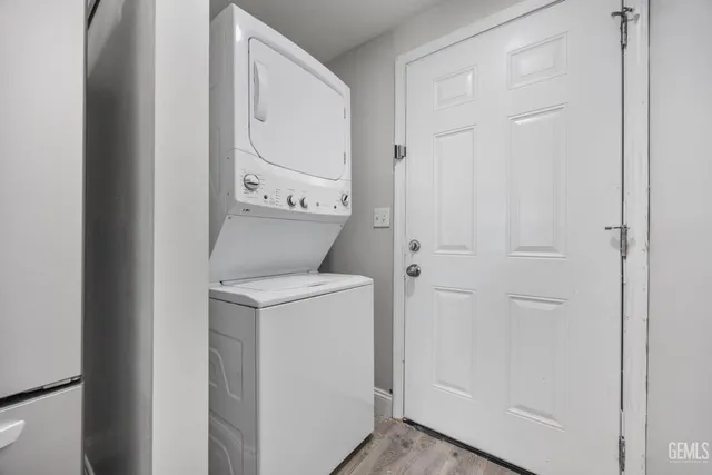 a view of washer and dryer with bathroom in the background